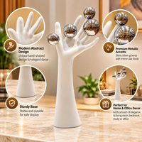 Anupam abstract hand figurine features with metallic silver accents