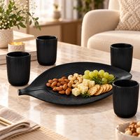 Anupam black leaf serving tray with four ribbed tumblers lifestyle image