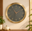 Anupam premium gold and charcoal round wall clock in modern interior